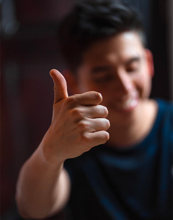 A man thumbs up after an increadible hair transplant